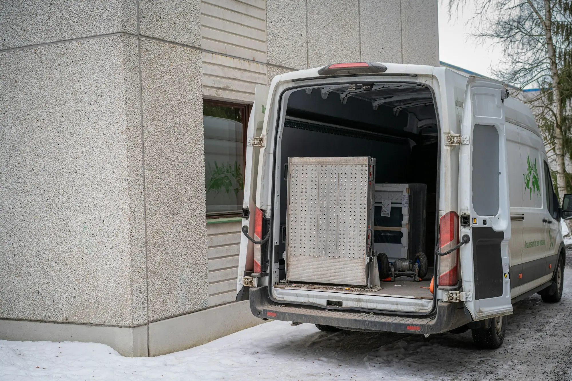 Delivery van with its back doors open, loaded with parcels for online orders